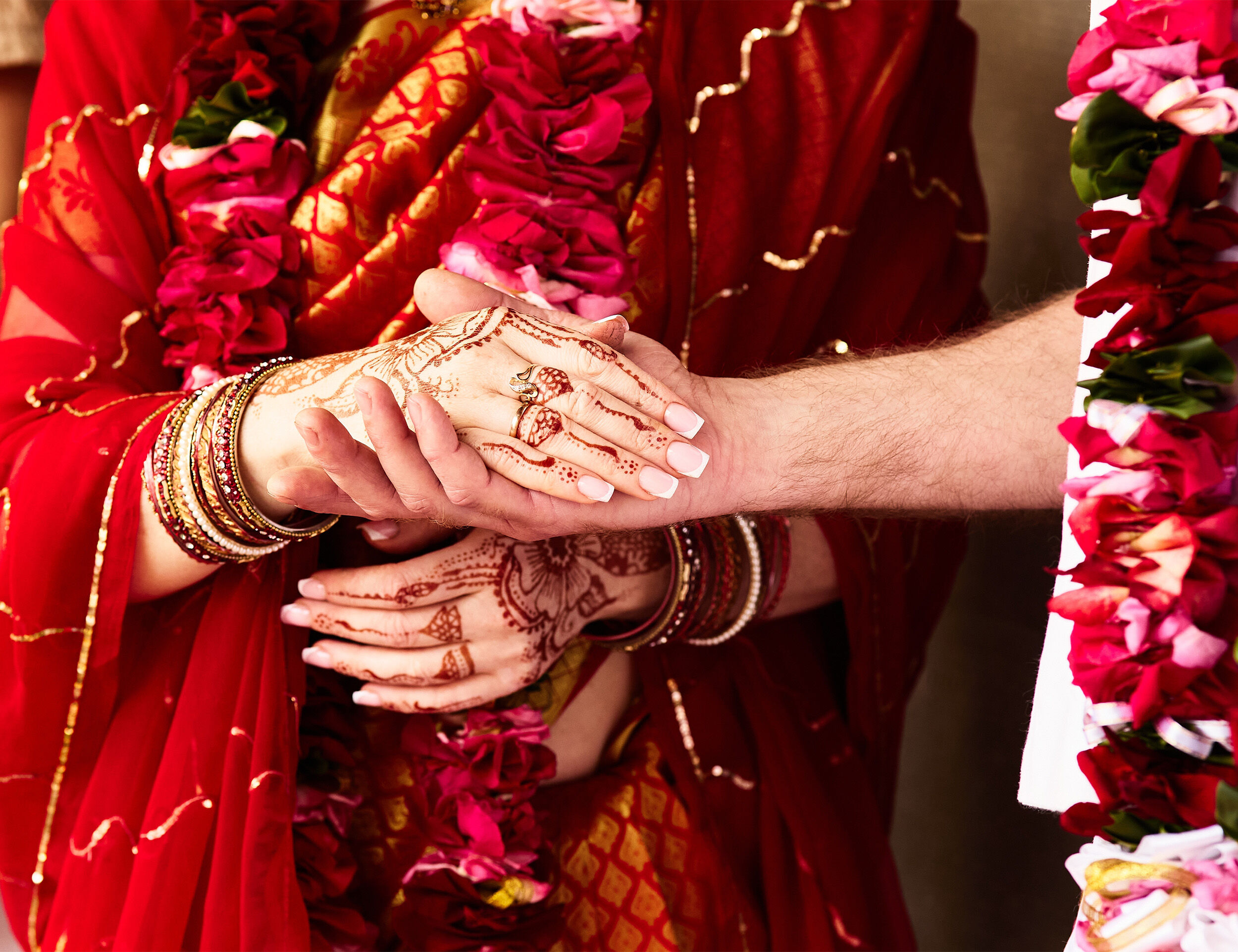 A bride and groom holding each others hand on their wedding day